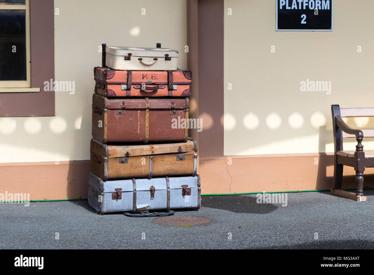 Vintage luggage suitcases stacked on train station platform Stock Photo