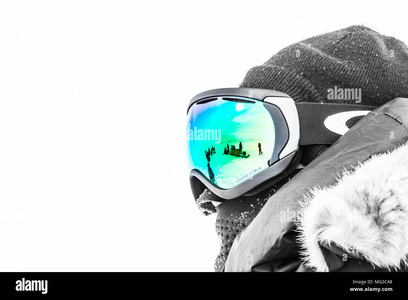 Unrecognisable but intrepid polar explorer with skidoo's reflected in the goggles.  Baffin Island, Canada, Arctic, Nunavut Stock Photo
