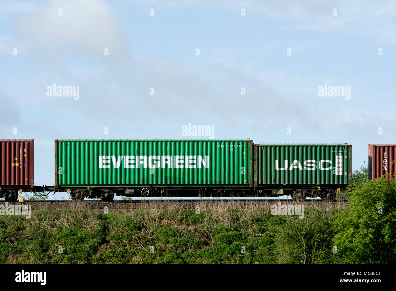 Evergreen and UASC shipping containers on a freightliner train, Warwickshire, UK Stock Photo