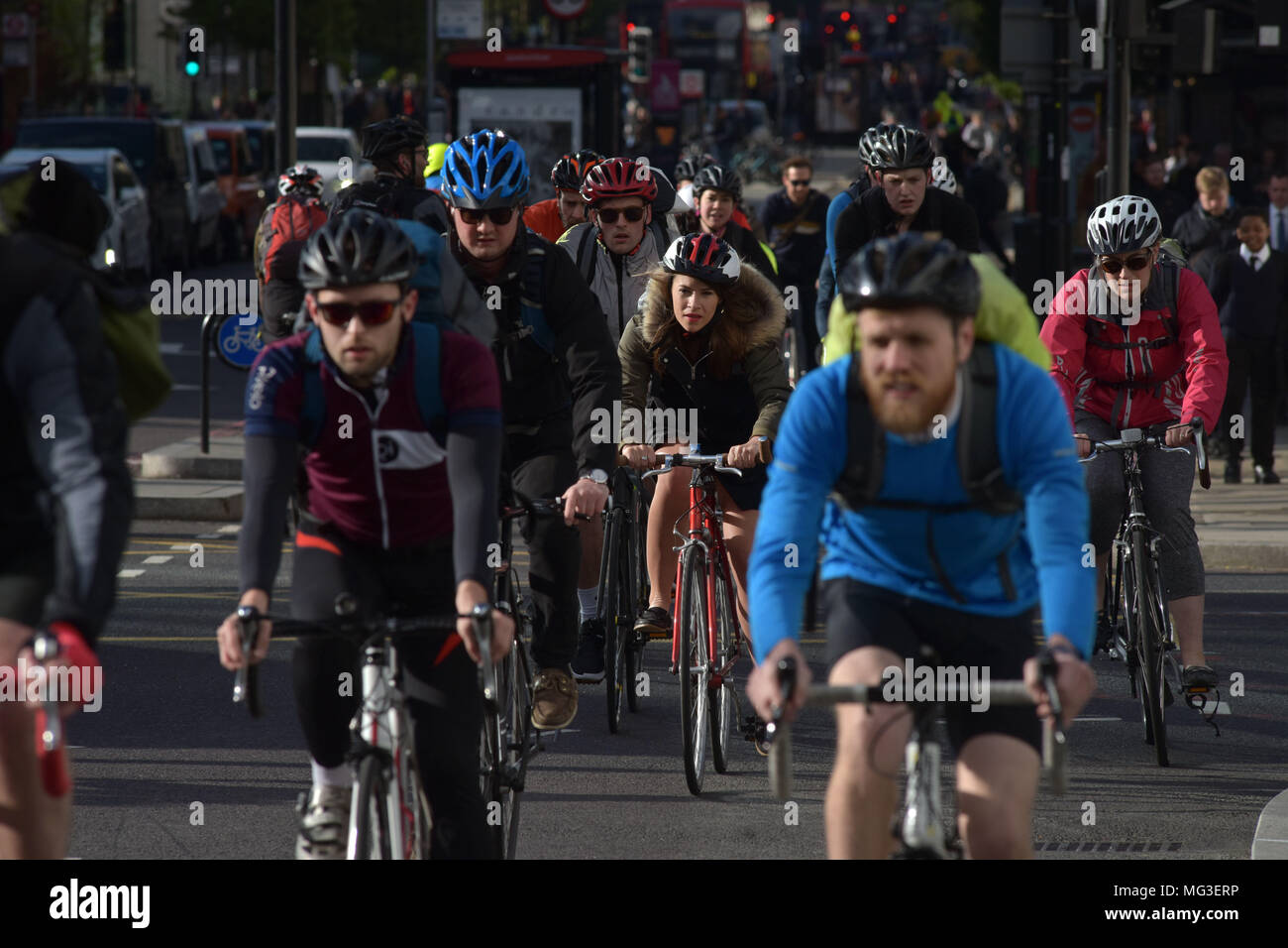 Cyclists ride across the traffic junction on Blackfriars Road and Stamford Street heading north towards Blackfrairs Bridge on the bicycle Superhighway Stock Photo