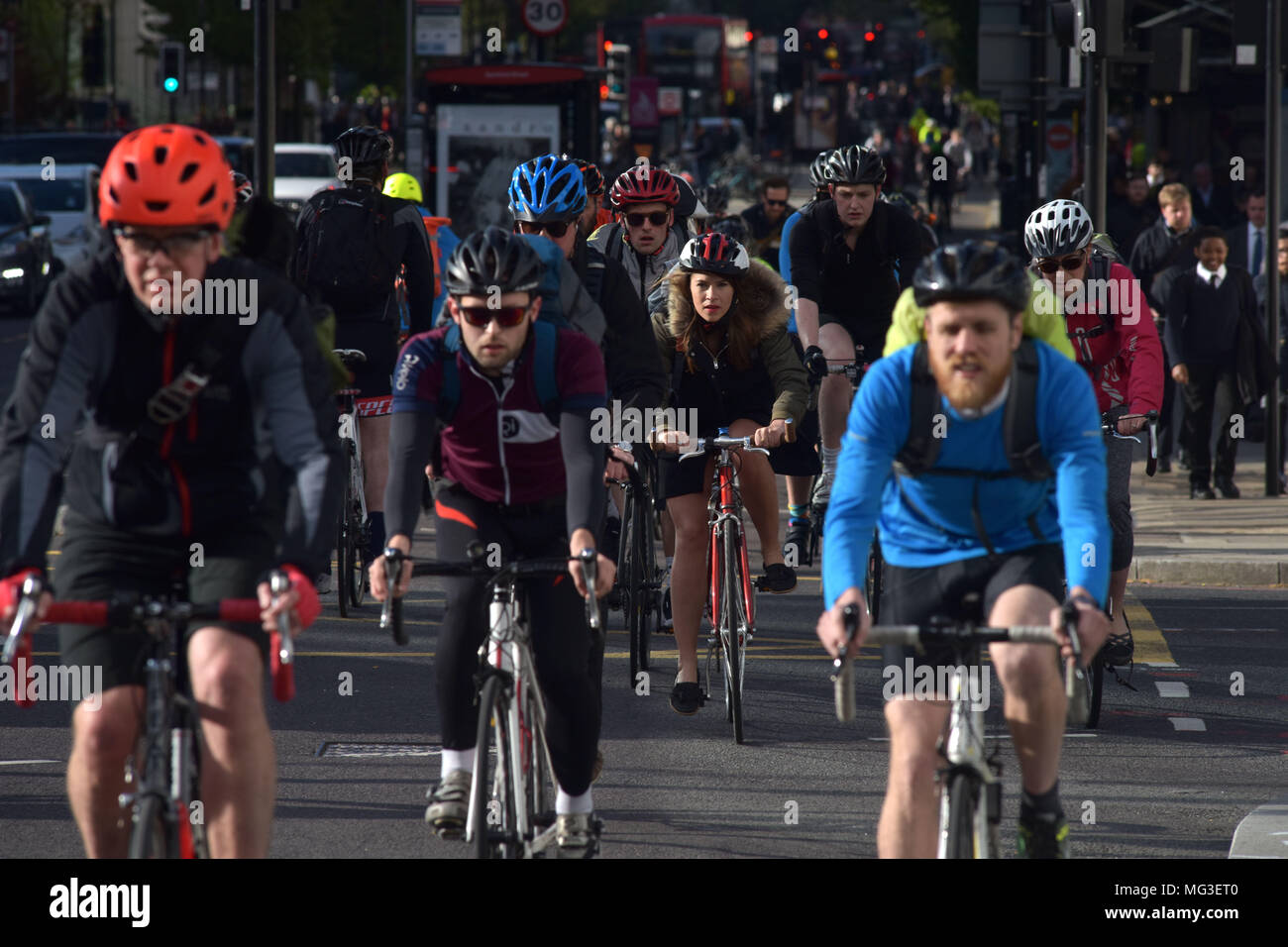 Cyclists ride across the traffic junction on Blackfriars Road and Stamford Street heading north towards Blackfrairs Bridge on the bicycle Superhighway Stock Photo