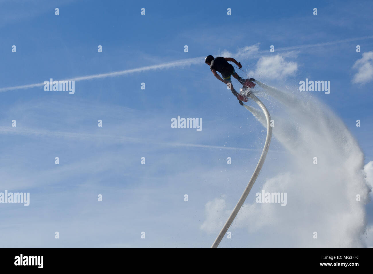 Flyboard - man exibition. Flyboarding session in the aquamarine waters. Stock Photo