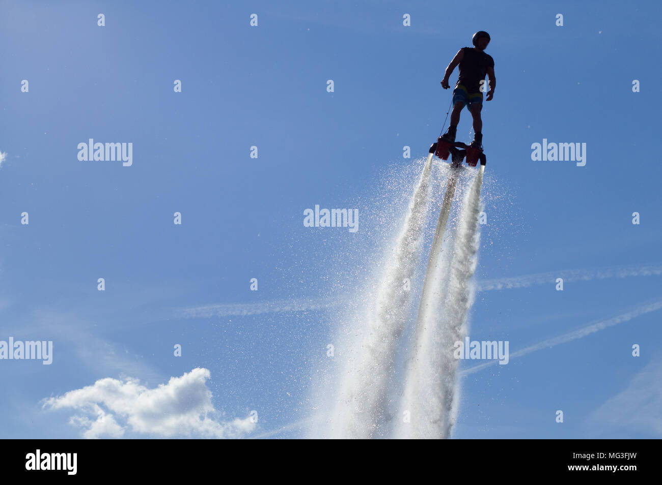 Flyboard - man exibition. Flyboarding session in the aquamarine waters. Stock Photo