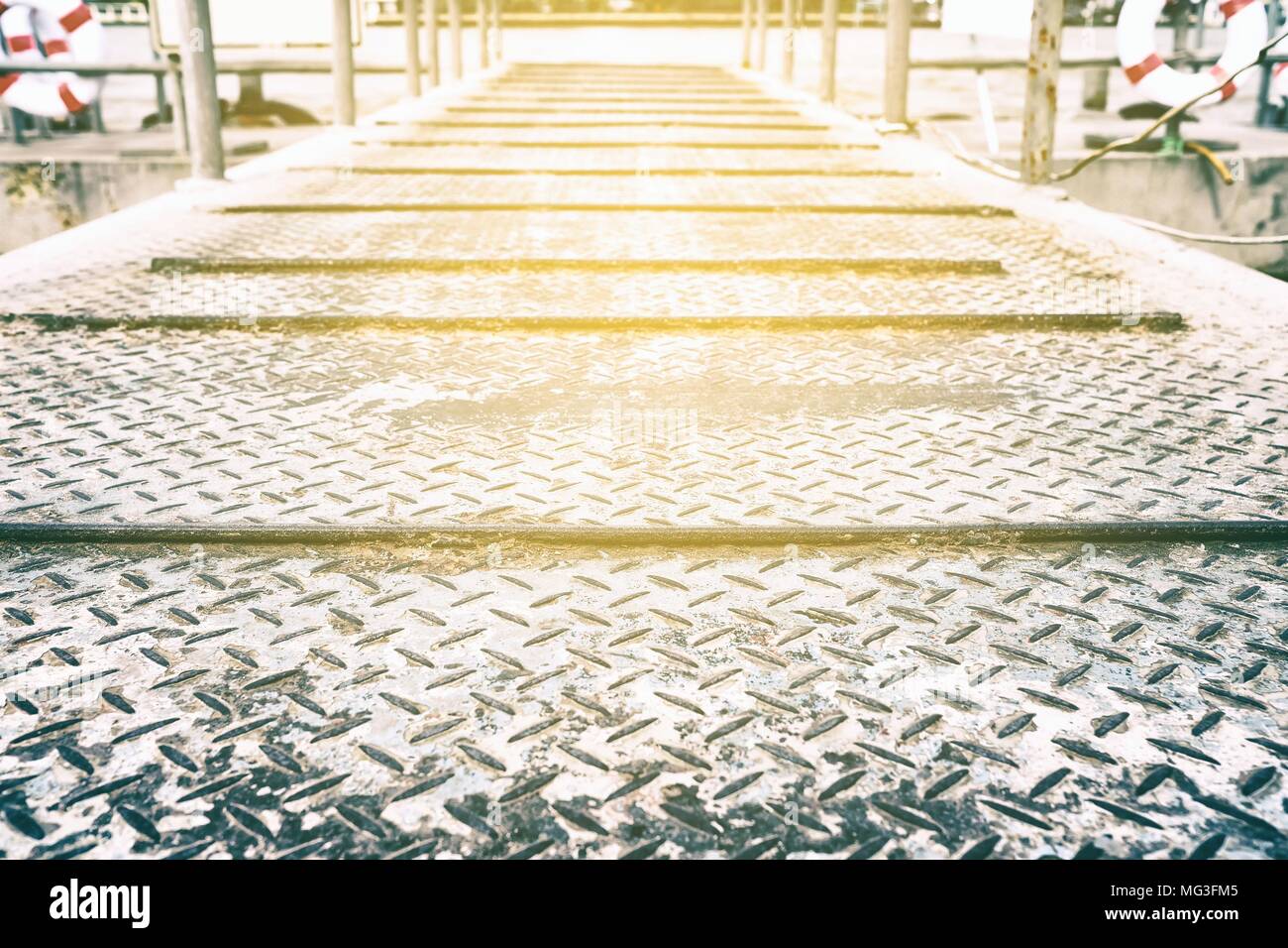 Diamond Plate Pathway to Pier Background with Light Leak. Stock Photo