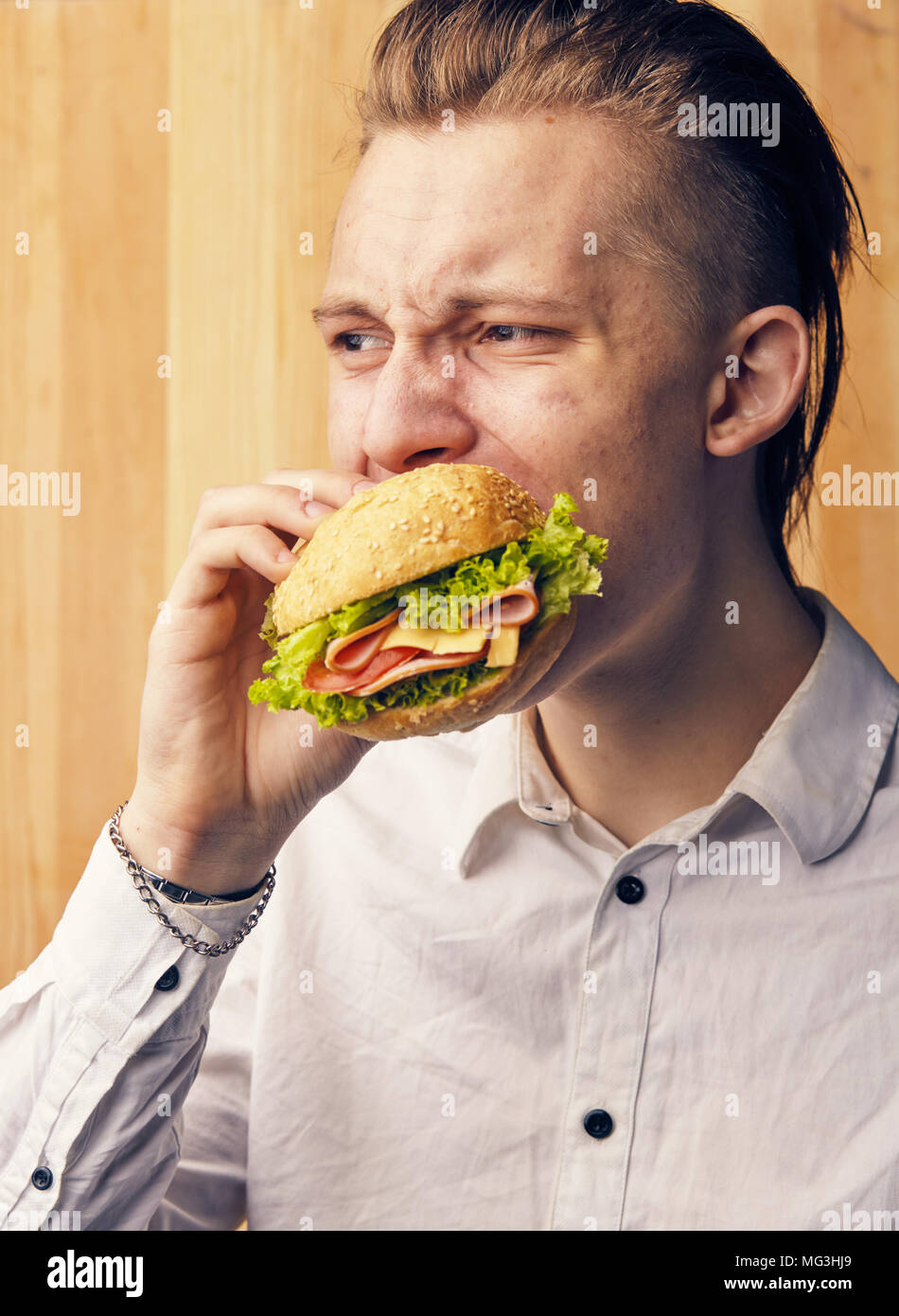 the young guy is really trying to burger Stock Photo