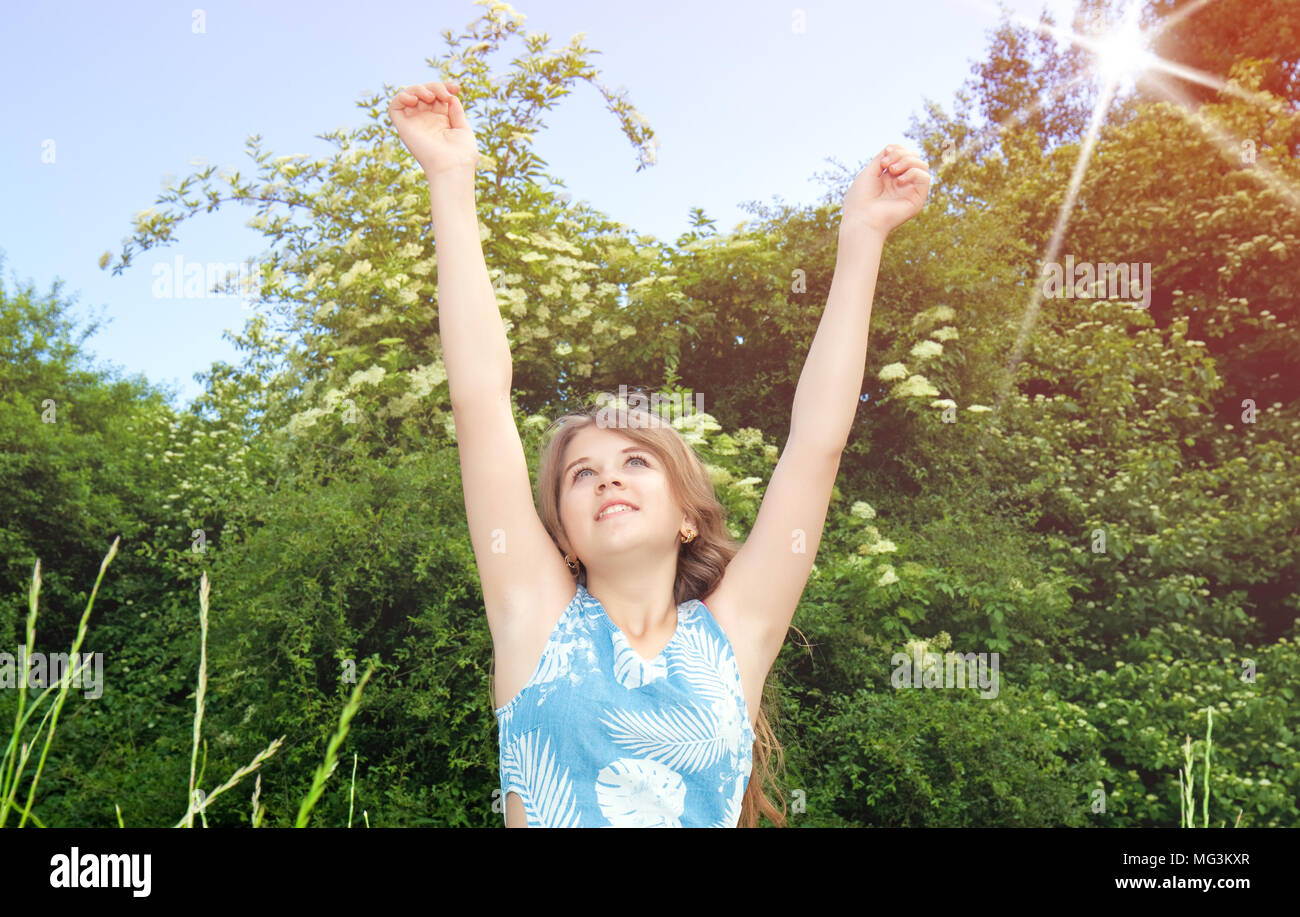 beautiful young girl with raised arms Stock Photo