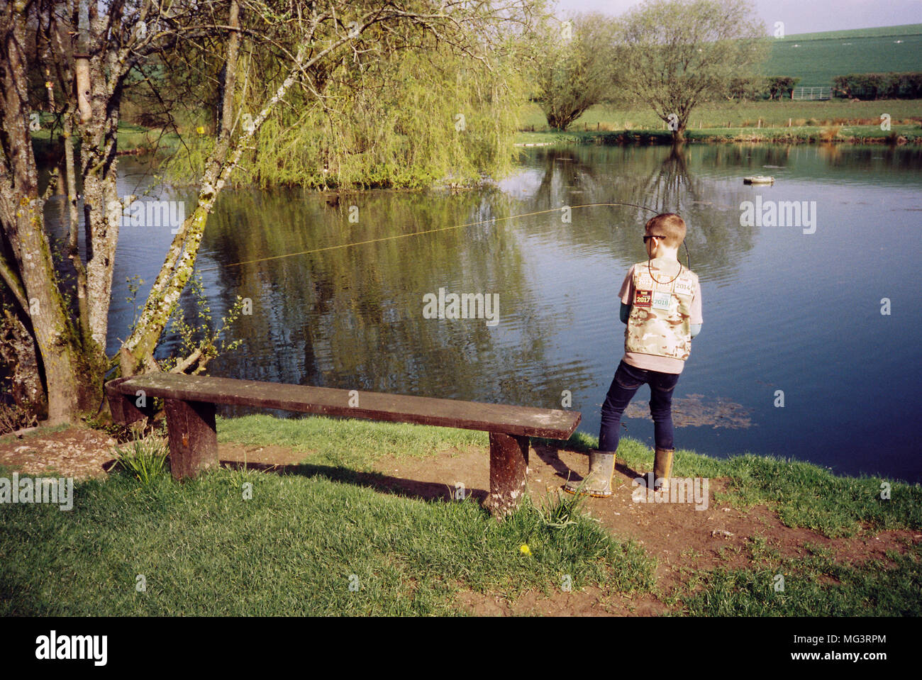 Nine year old boy fly fishing for trout at Moorhen trout fishery