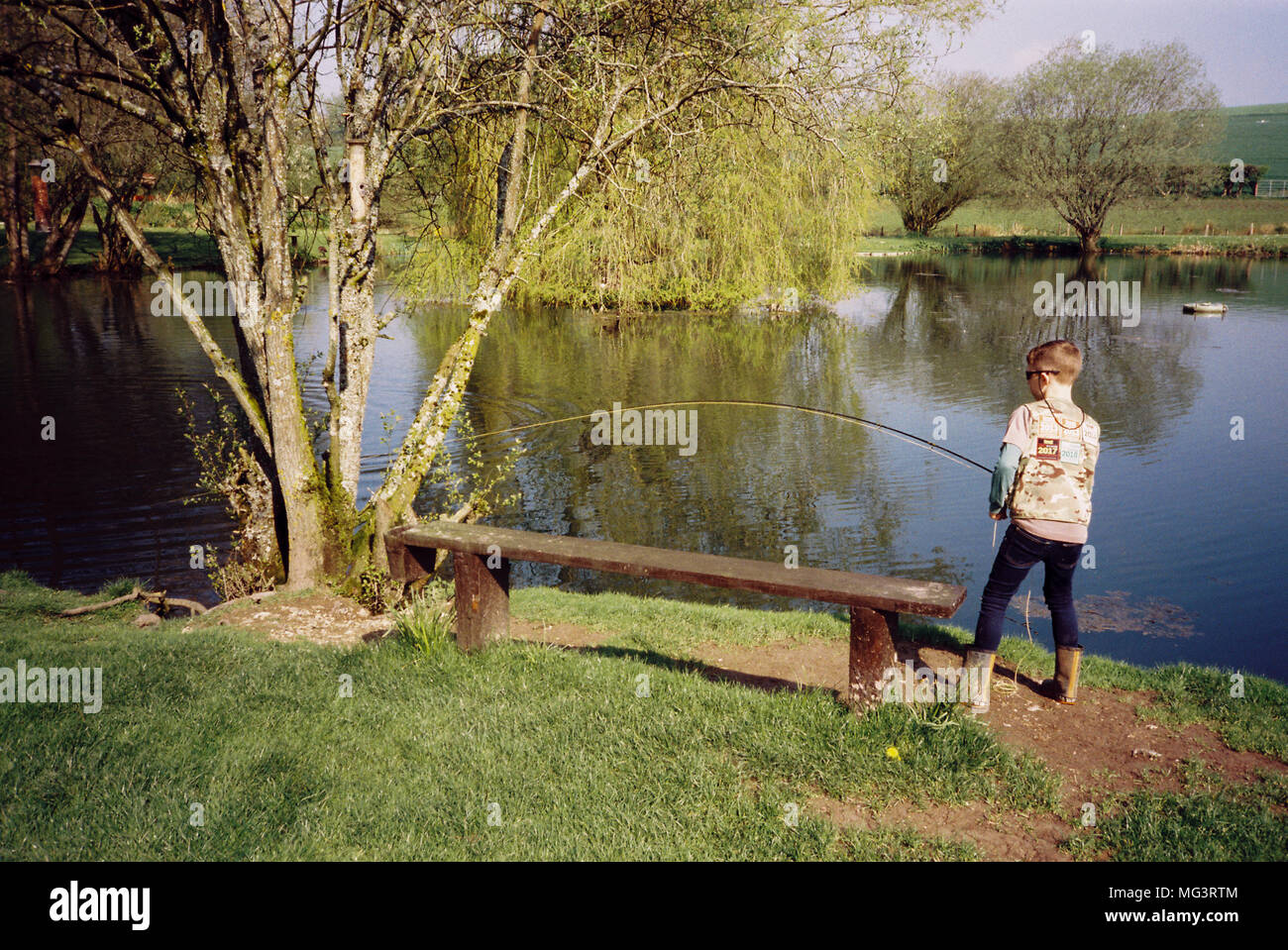 Nine year old boy fly fishing for trout at Moorhen trout fishery