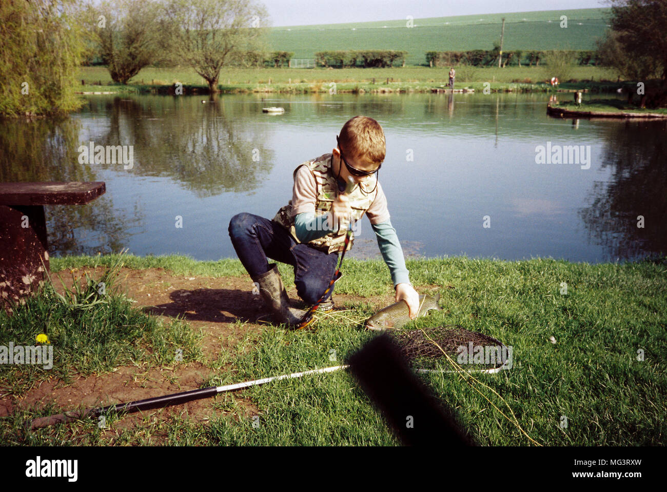 Nine year old boy fly fishing for trout at Moorhen trout fishery