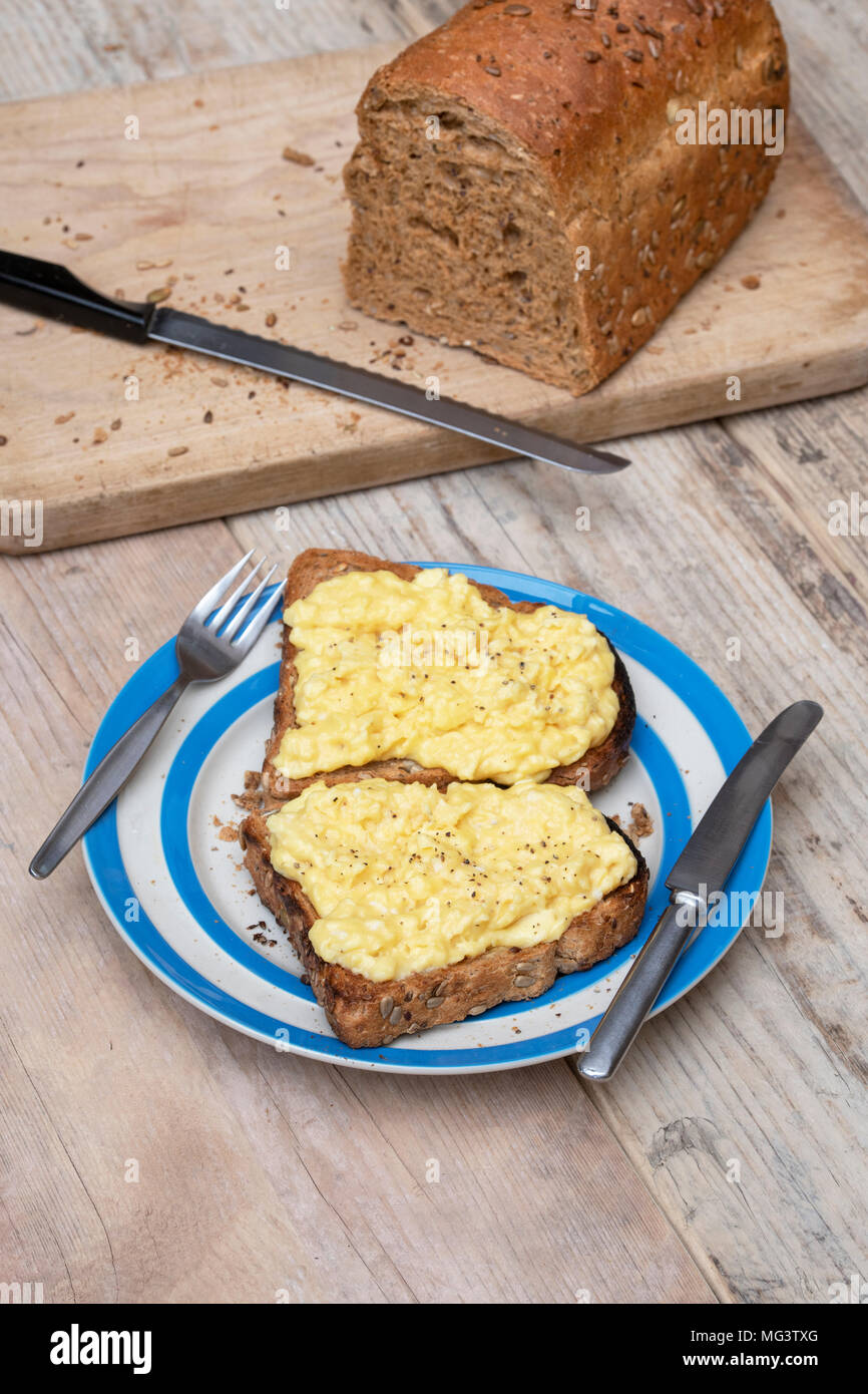 Scrambled eggs on two pieces of toast Stock Photo