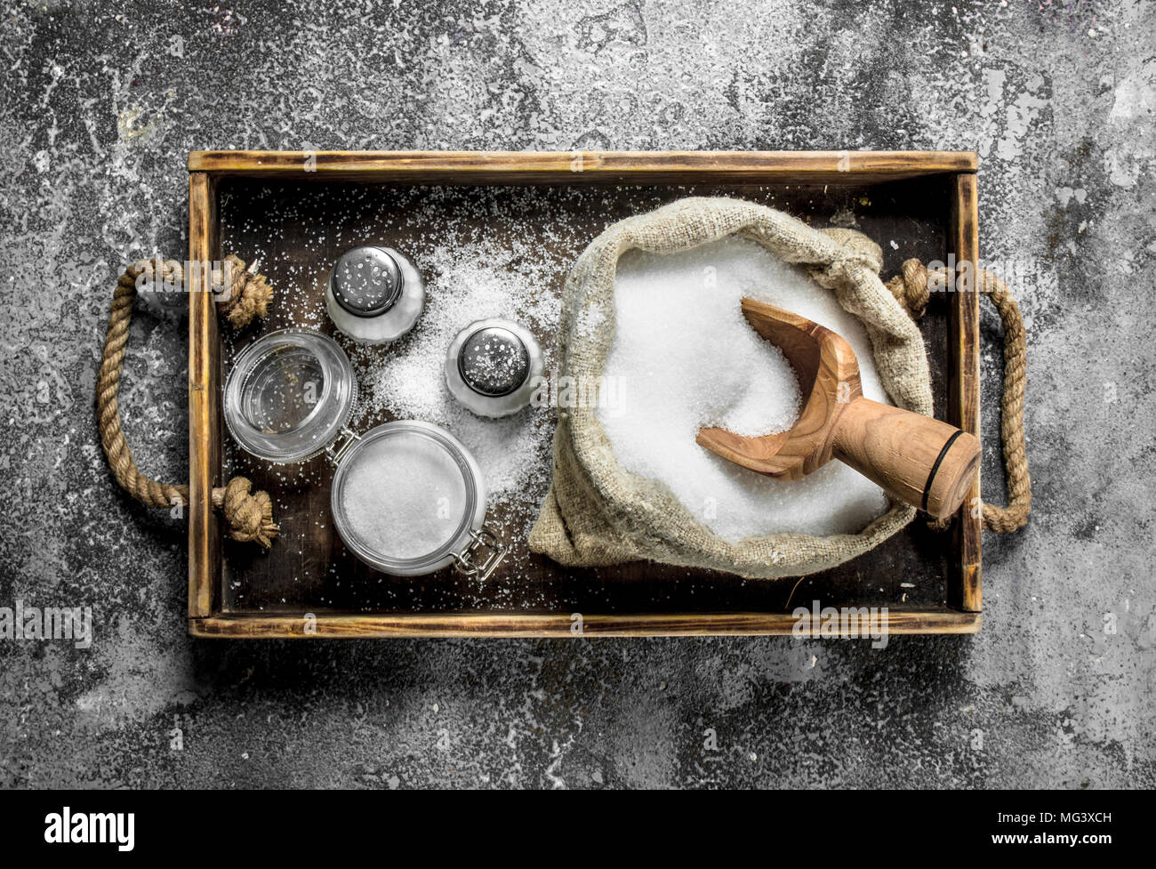 Salt in an old bag on a tray. On rustic background Stock Photo - Alamy