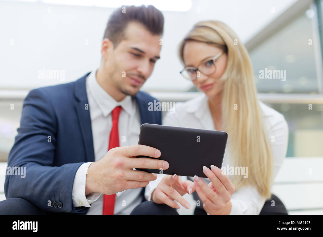 Young businesspeople holding tablet in financial center, depth of field, selective focus Stock Photo