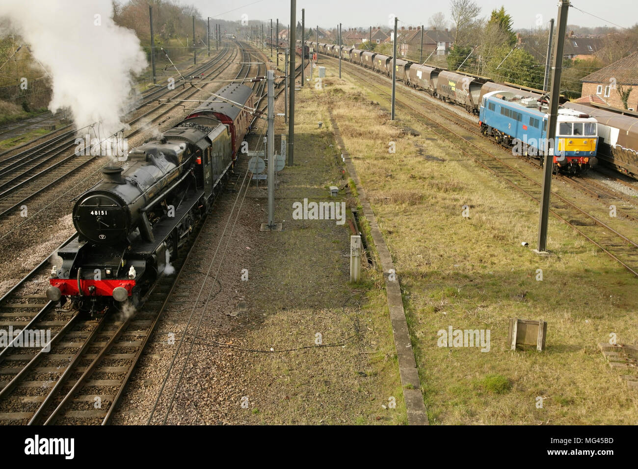 Preserved LMS Stanier class 8F steam locomotive no. 48151 and Class 86 loco 86259 'Les Ross' at Holgate sidings, York, UK. Stock Photo