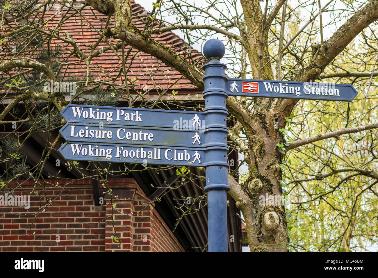 Direction sign to attractions, amenities and facilites in Woking, Surrey, UK: Woking Park, Leisure Centre, Woking Football Club, Woking Station Stock Photo