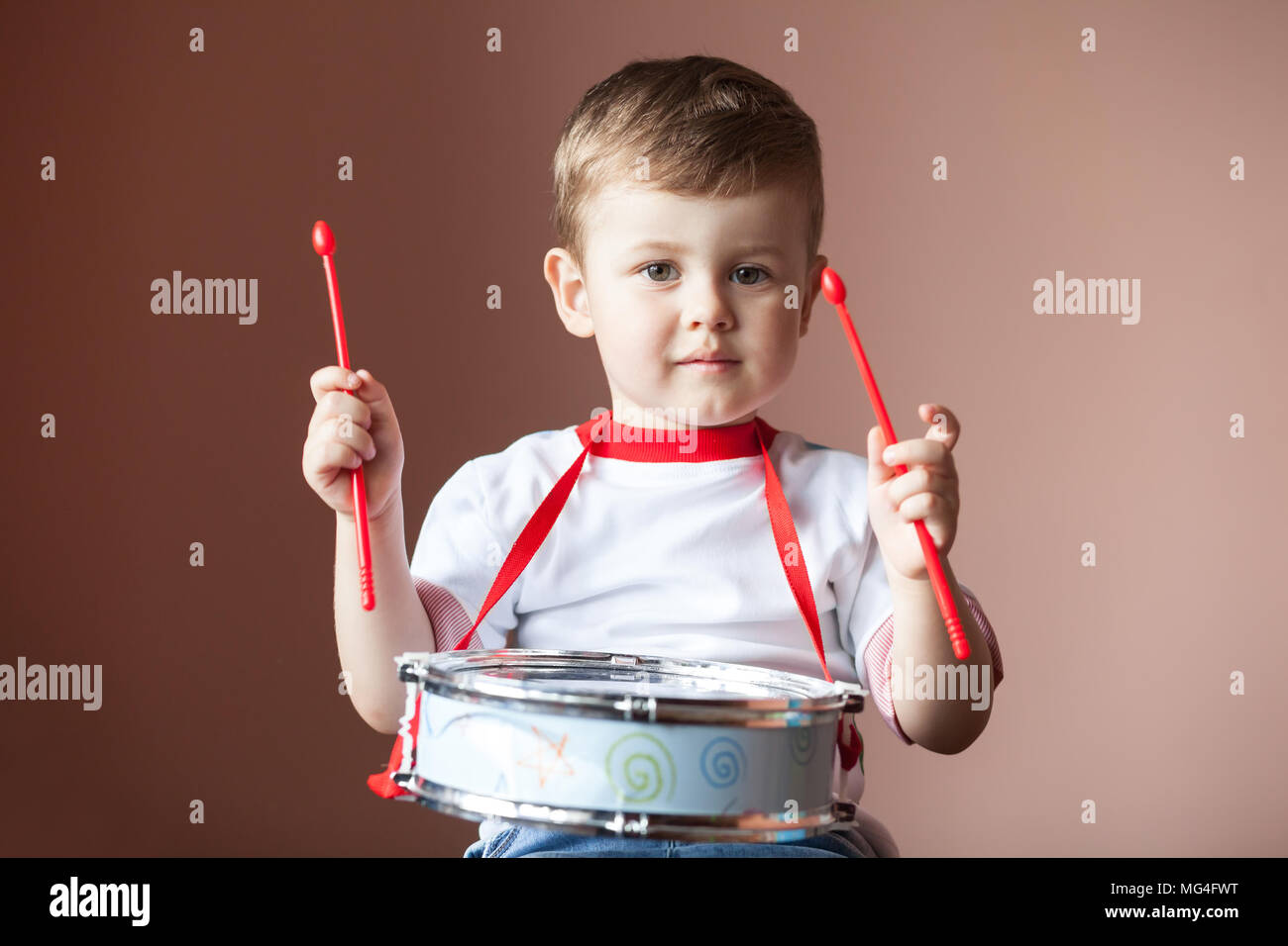 Little boy playing the drum. Child development concept Stock Photo Alamy