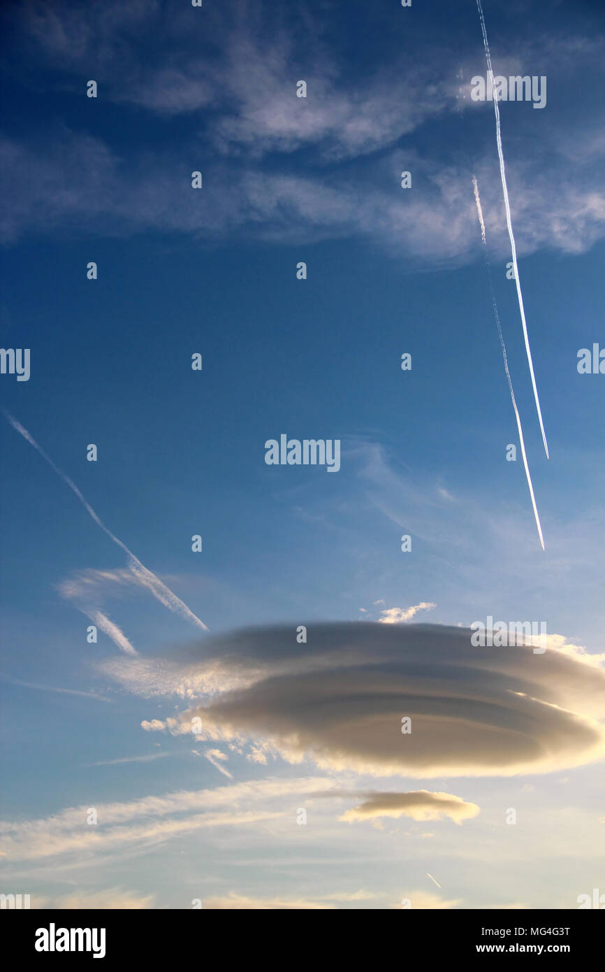 Lenticular clouds over the blue sky Stock Photo