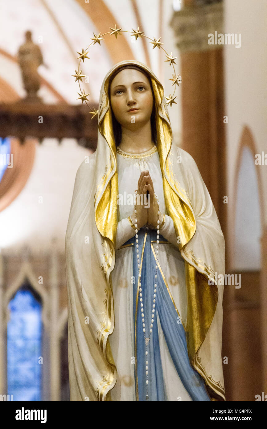 A statue of Our Lady of Lourdes in the 'Santa Maria del Carmine' church (Holy Mary of Carmel) in Pavia, Italy. - Stock Image