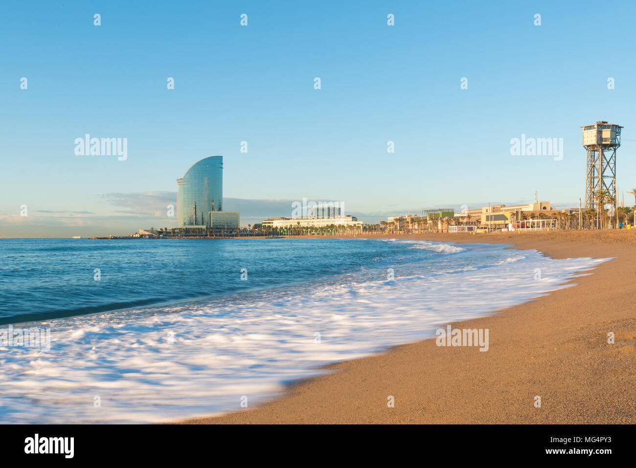 Barceloneta Beach in Barcelona with colorful sky at sunrise. Seafront, beach,coast in Spain. Suburb of Barcelona, Catalonia Stock Photo