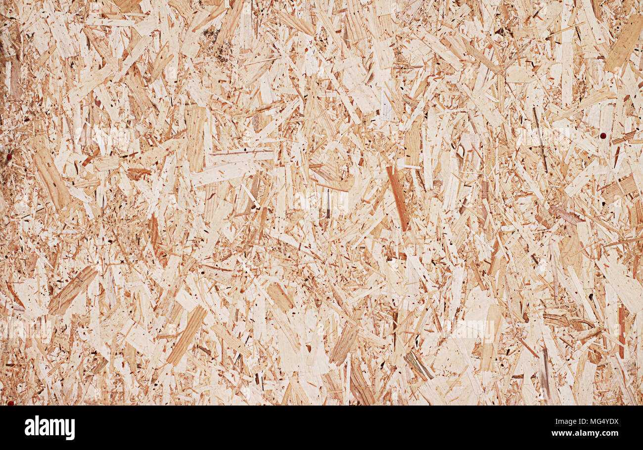 Fiberboard. Compressed light brown wooden plywood texture. Close up