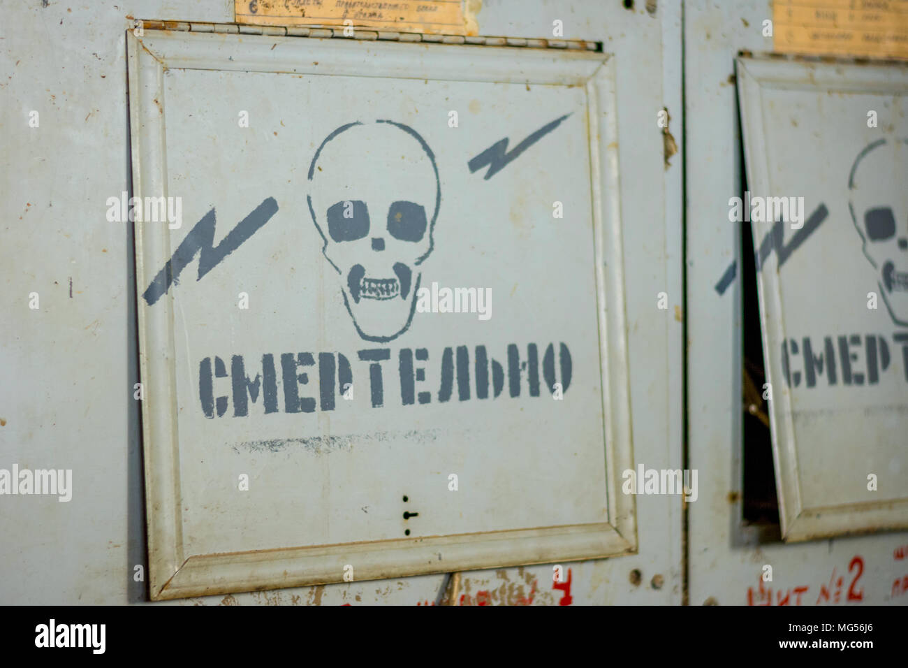 Old electricity box with the 'life danger' warning in russian Stock Photo