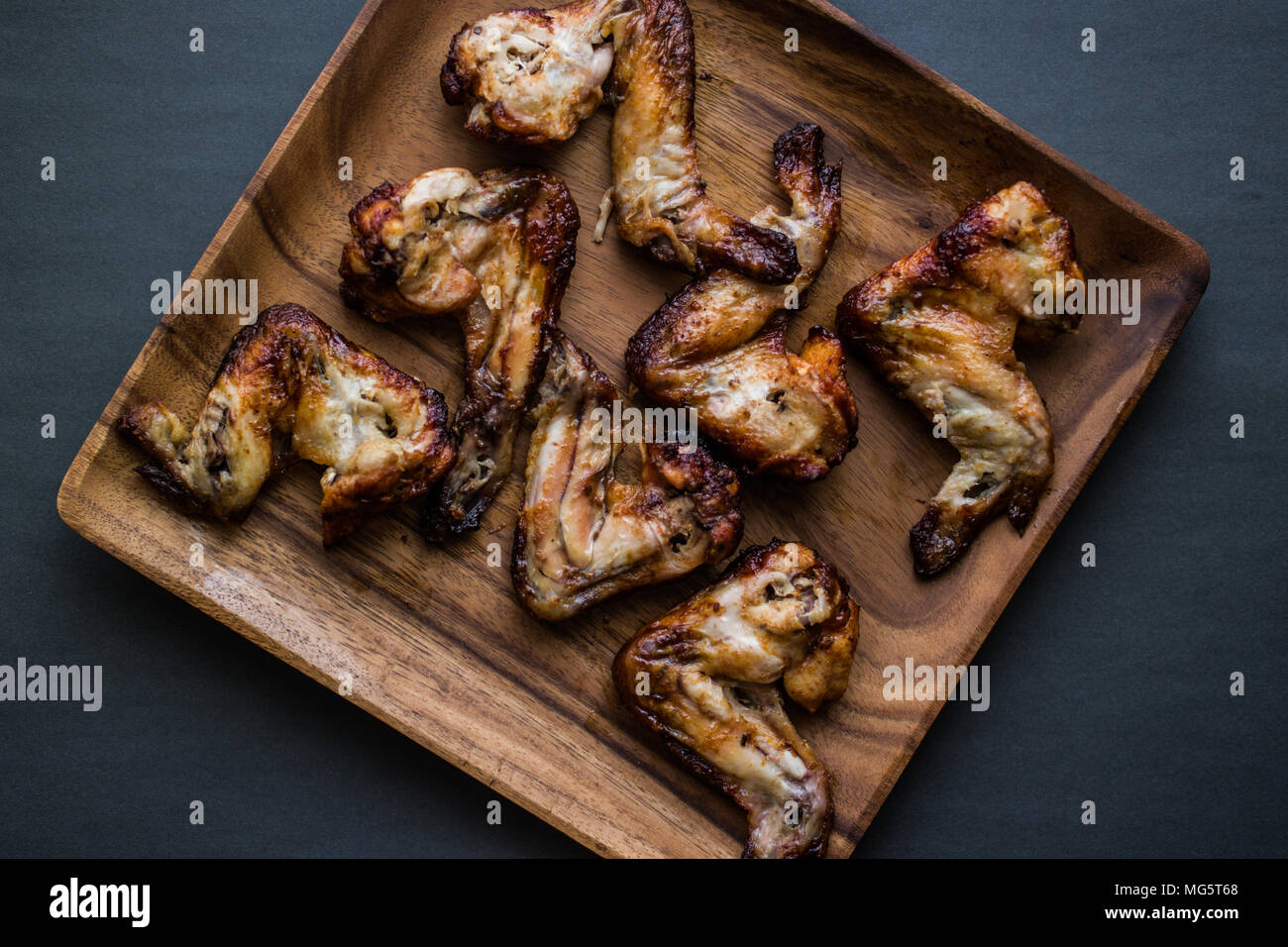 A type of food, a serving of the wing sections of a chicken, deep fried wings coated in sauce