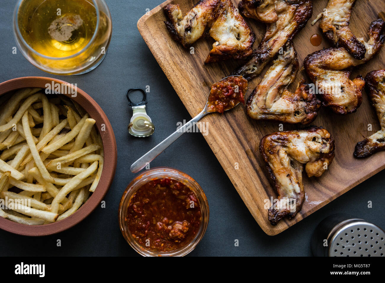 A type of food, a serving of the wing sections of a chicken, deep fried wings coated in sauce