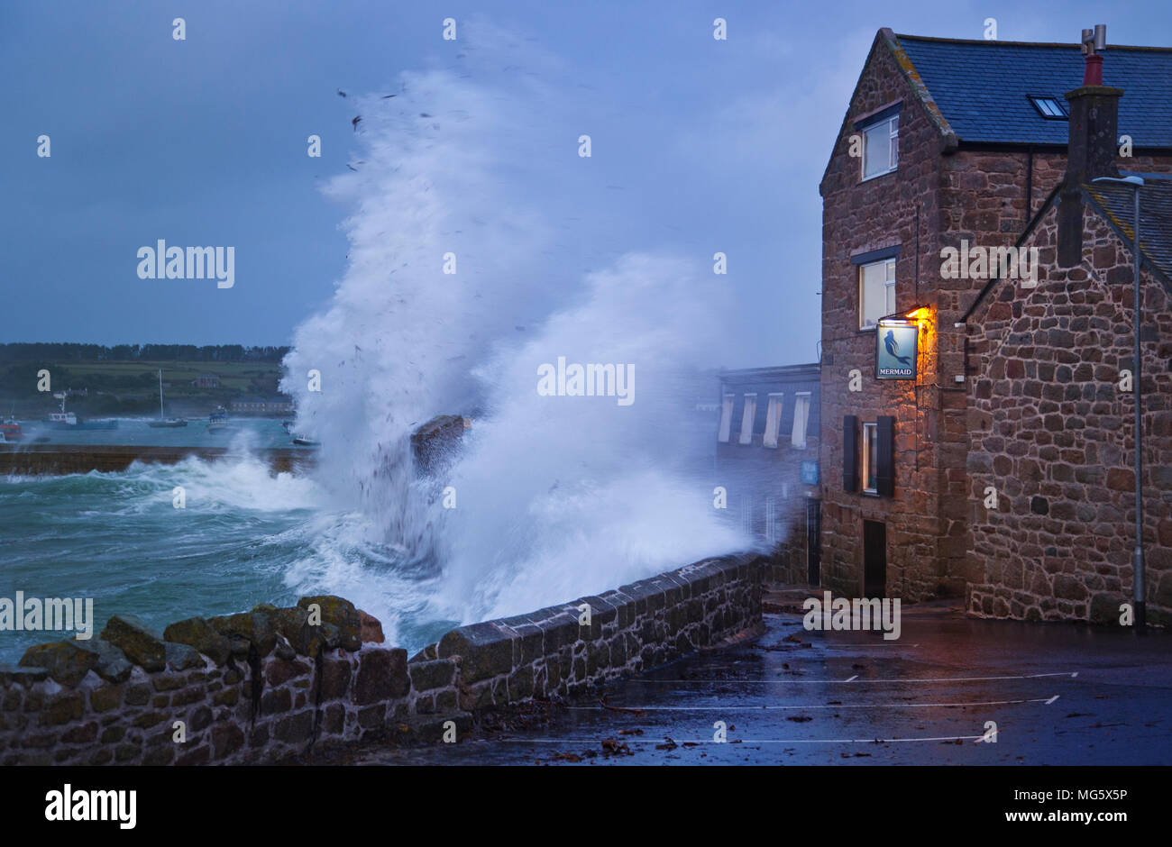 Waves crashing over the Mermaid inn in St Marys on the Isles of Scilly, UK Stock Photo