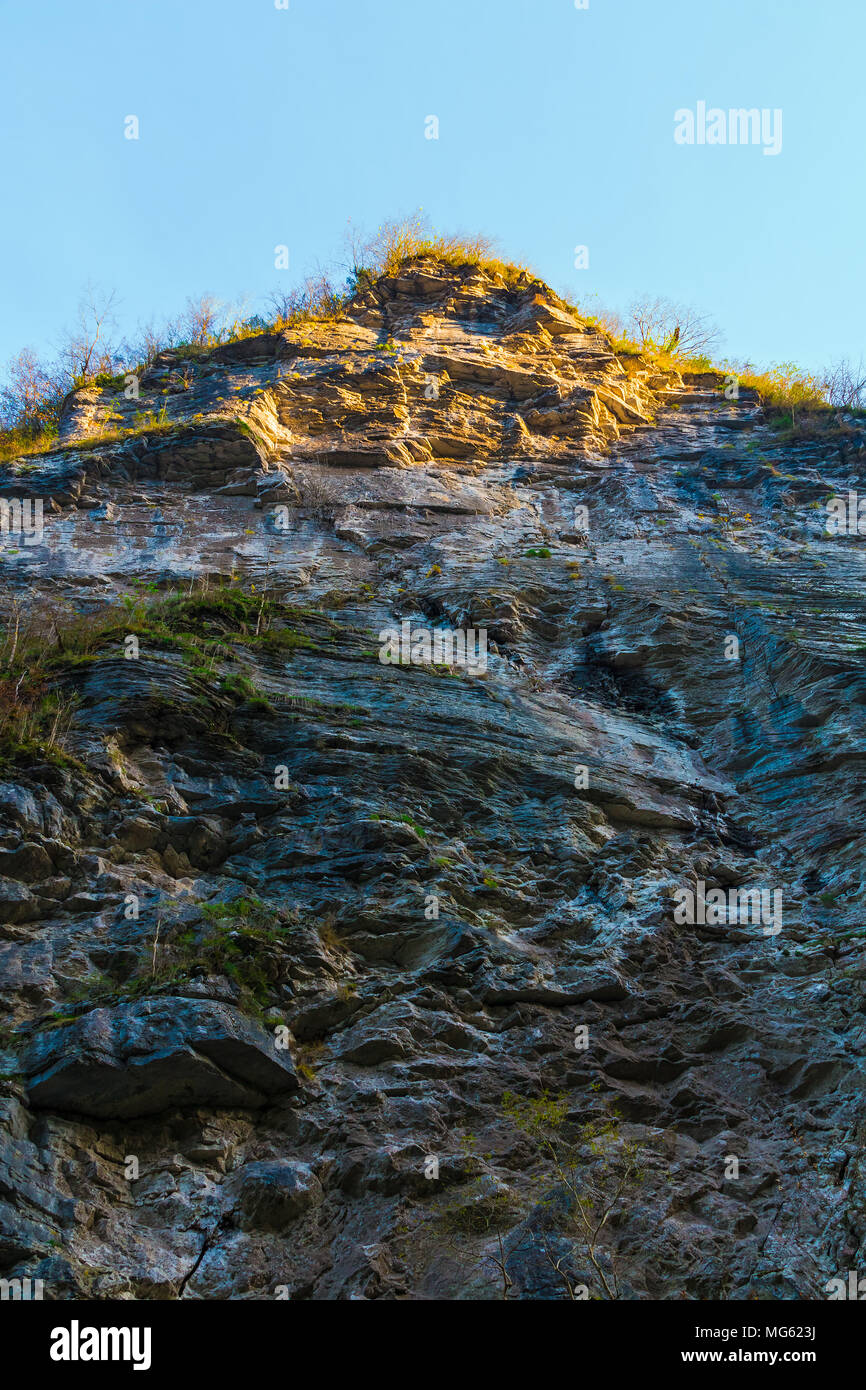 Low Angle View Of A High Steep Rocky Mountain With Cliff Illuminated By The Sun Stock Photo Alamy