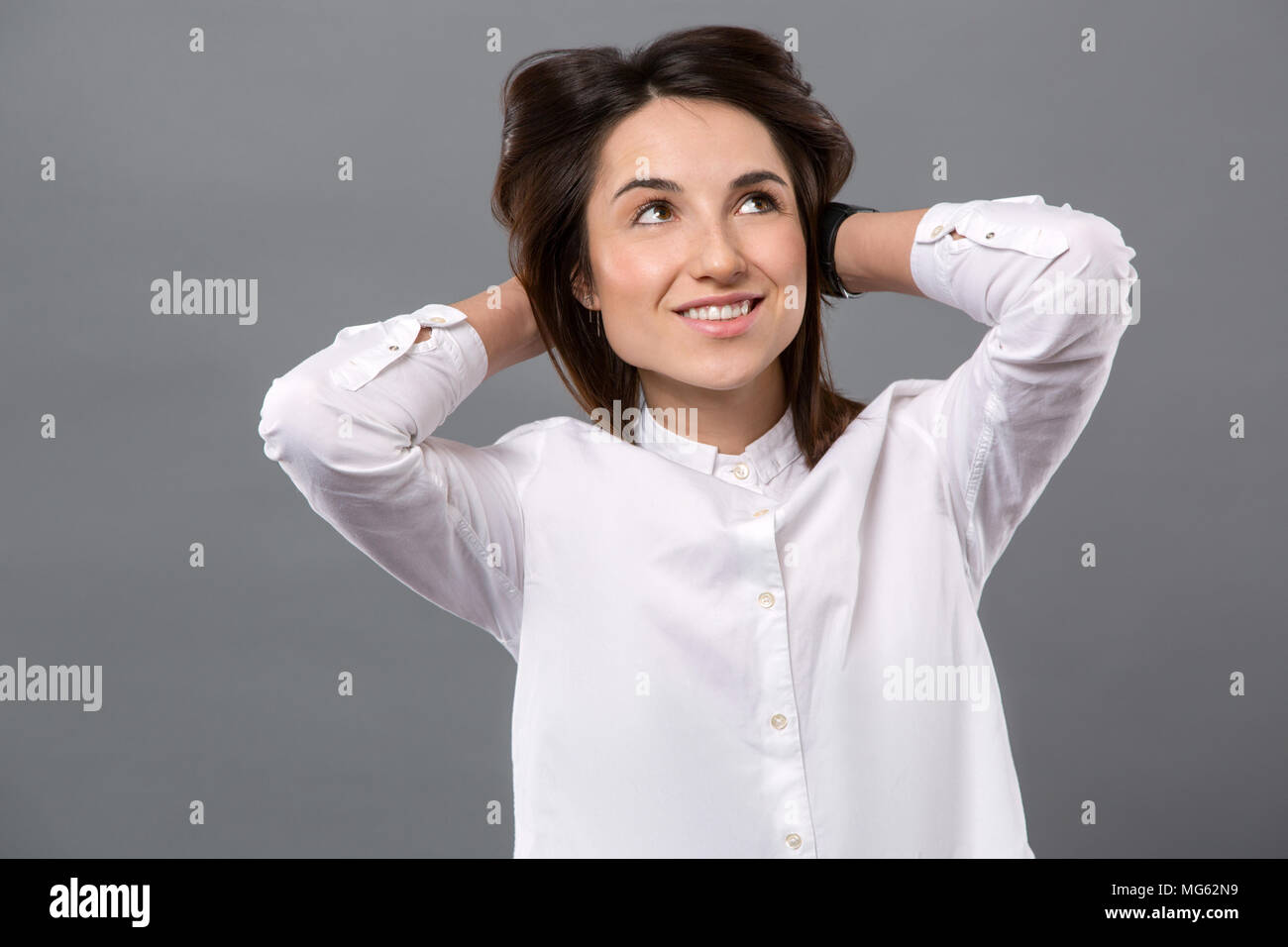 Nice happy woman being in a dreamy mood Stock Photo