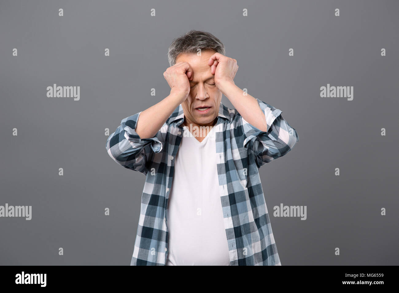 Nice tired man touching his face Stock Photo