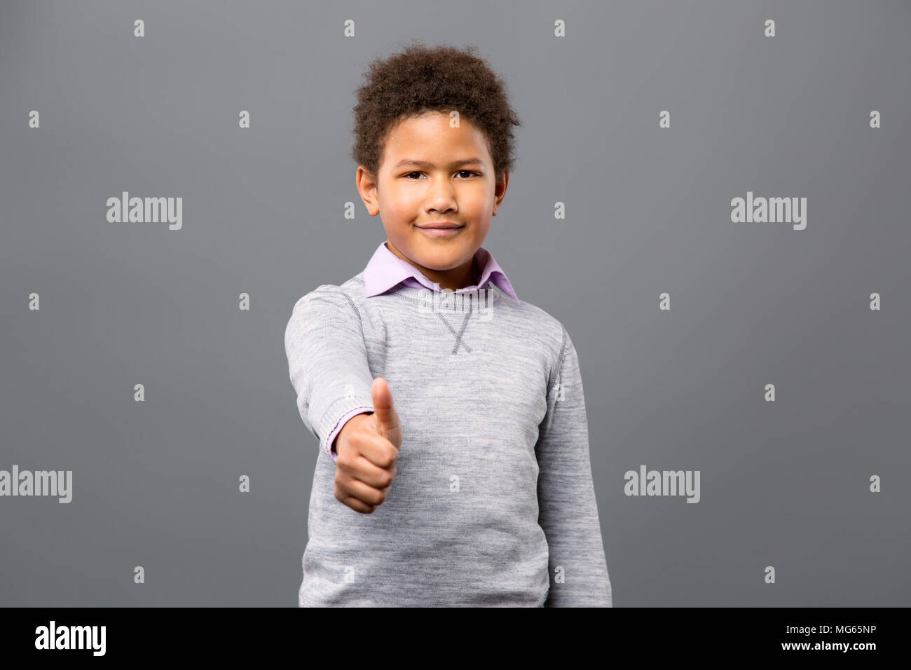 Joyful nice boy showing thumbs up gesture Stock Photo - Alamy