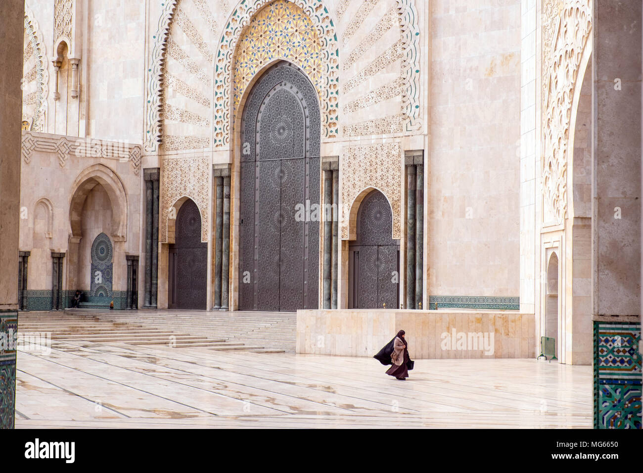 Woman in islamic dress walks through The Hassan II Mosque or Grande Mosquée Hassan II. Casablanca, Morocco Stock Photo
