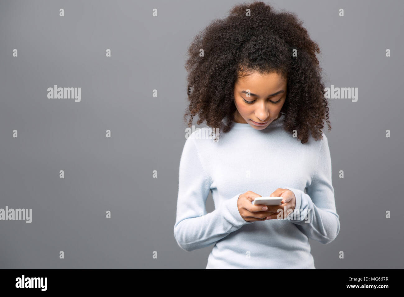 Nice serious woman typing a message Stock Photo