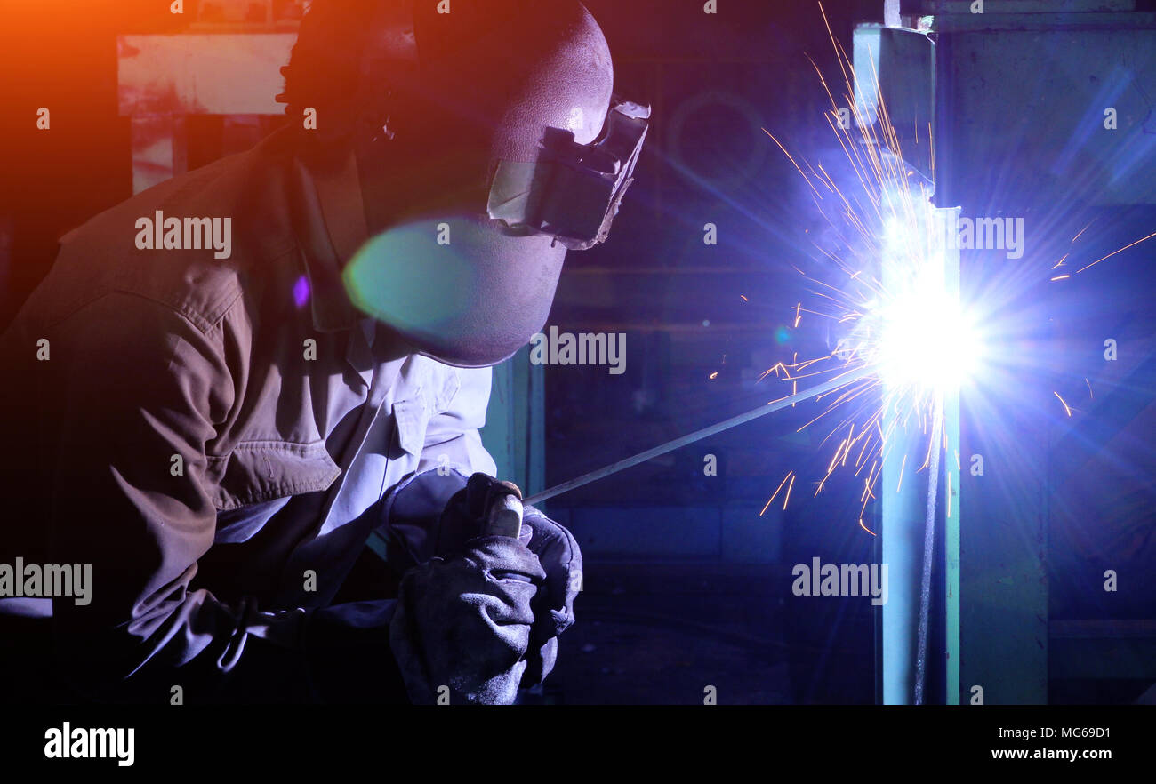 Industrial worker Welding and bright sparks. Hard job Stock Photo