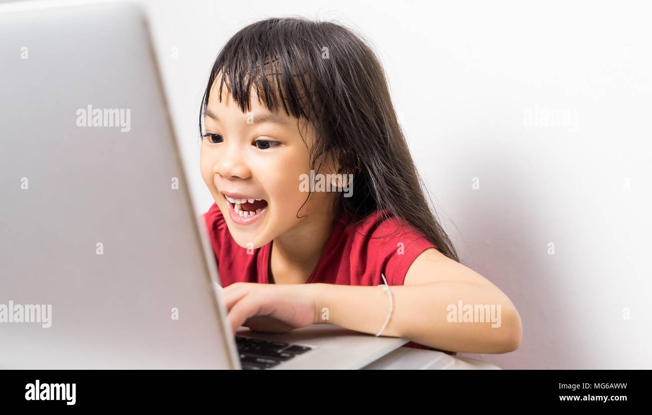 Asian girl is having fun surfing the internet. Stock Photo