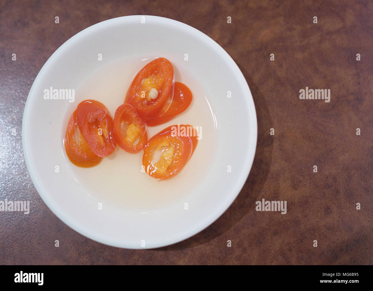Red chili in vinegar Stock Photo Alamy