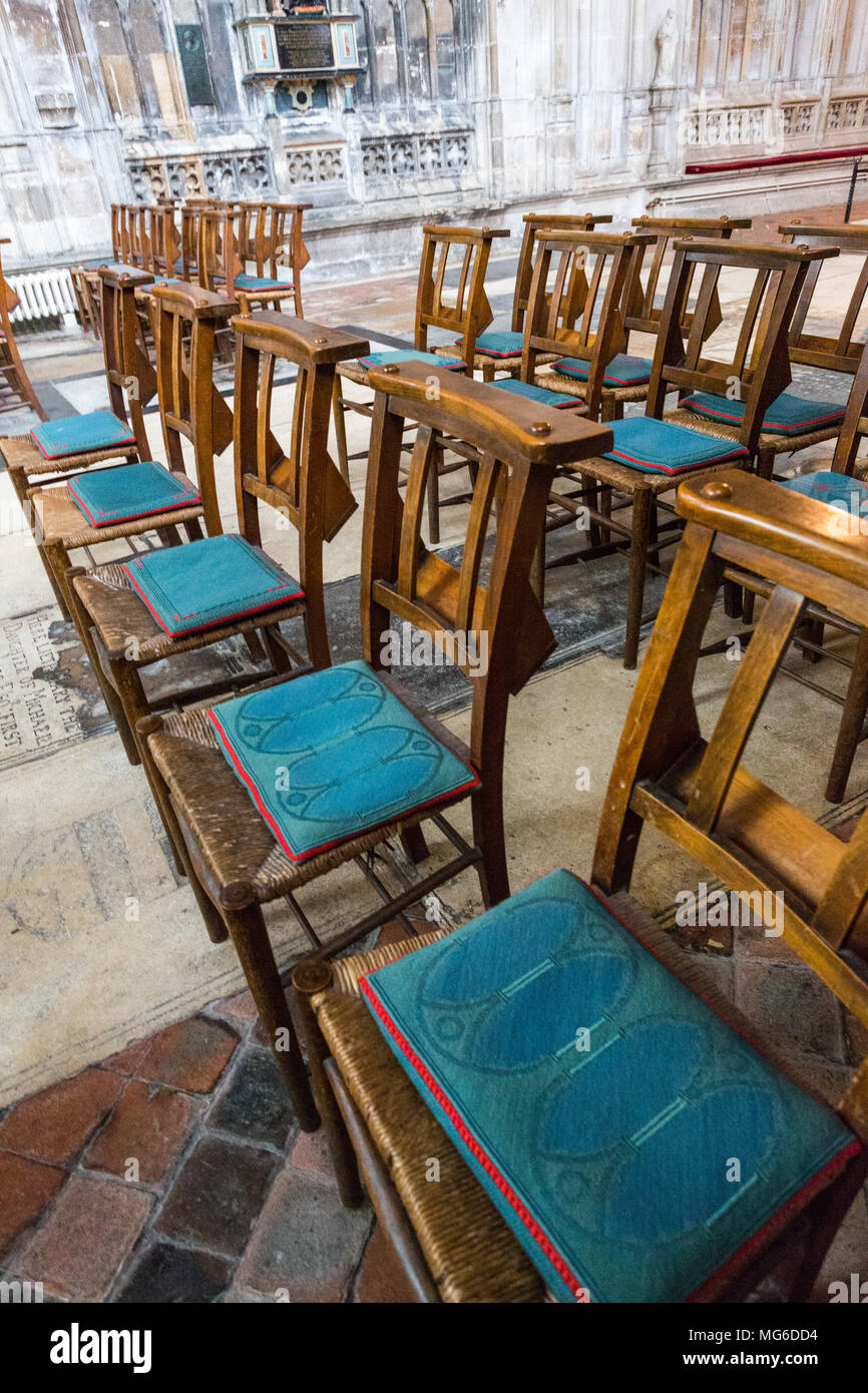 Gloucester, United Kingdom - March 28, 2015: In a backroom in Gloucester Cathedral are wooden chairs with blue seat cushions. Stock Photo
