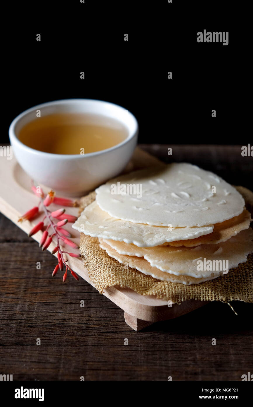 Coconut biscuits curl or Tong Muan, thai sweetmeat made of flour, coconut milk and egg. Stock Photo