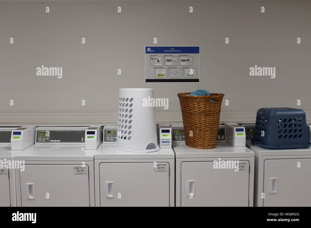 Powerful laundry machines and automatic dryers in big laundromat with a