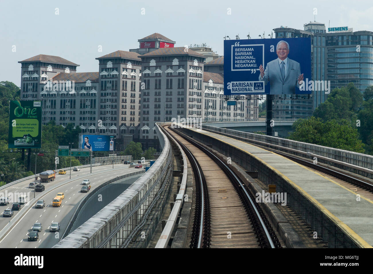 A huge billboard with the image of Malaysian prime minister, Najib Razak of the Barisan National Party is seen in the background ahead of the 14th general election in Kuala Lumpur, Malaysia on April 27, 2018. According to supporters of Najib Razak, the MRT is one of the greatest achievements during the prime minister's term. The 14th general election of Malaysia will be held on May 9. Stock Photo