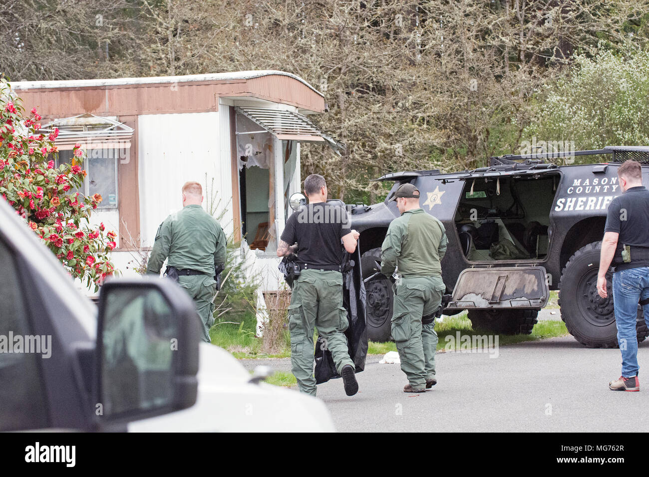 Shelton, Washington, USA, 27 April 2018.  Mason County Sheriff respond to the scene where a man stabbed a process server.  This was taken after the man was arrested and taken to the hospital witha dog bite wound.  It appears that police rammed the trailer with their SWAT vehicle.  Hidden Haven Mobile Home park scene of stand off today in Mason County. (Shawna Whelan) Credit: Shawna Whelan/Alamy Live News Stock Photo