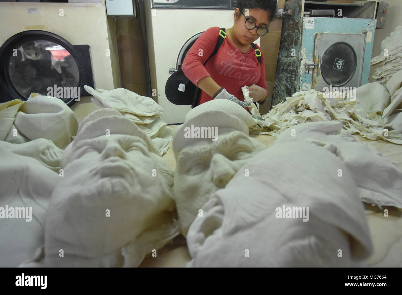A worker girl seen manufacturing masks of the U.S. president Donald ...