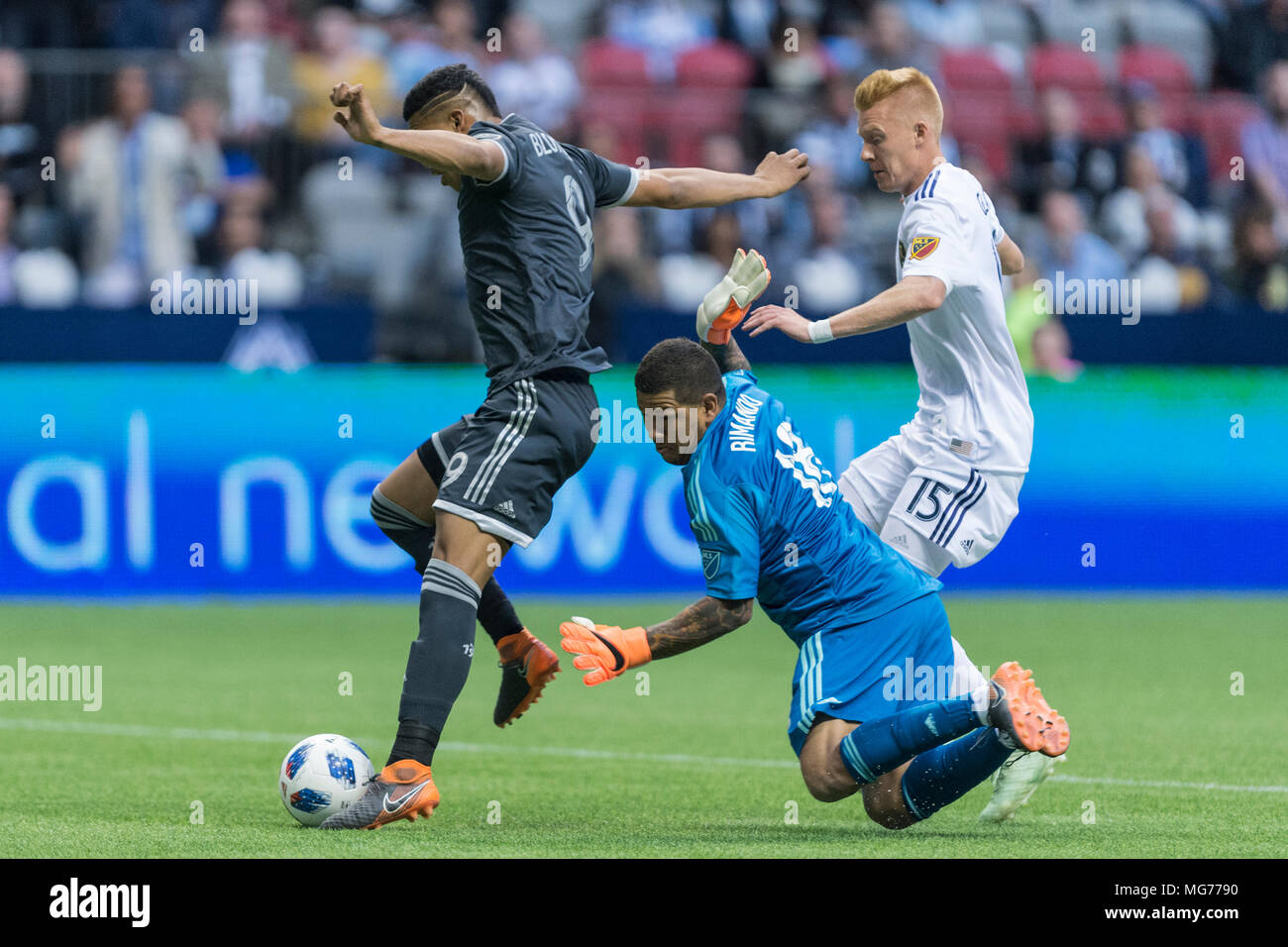 Vancouver, Canada. 27 April 2018. Anthony Blondell (9) of Vancouver Whitecaps getting past Goalkeeper Nick Rimando (18) of Real Salt Lake.  Vancouver Whitecaps vs Real Salt Lake BC Place. Vancouver wins 2-0 © Gerry Rousseau/Alamy Live News Stock Photo