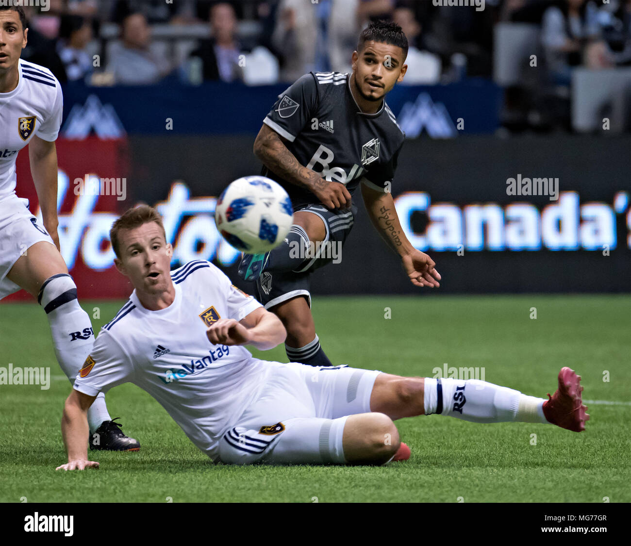 Vancouver, Canada. 27th Apr, 2018. Vancouver Whitecaps' Cristian Techera (top) vies with Real Salt Lake's Nick Besler during the Major League Soccer (MLS) regular season soccer match between Vancouver Whitecaps and Real Salt Lake in Vancouver, Canada, on April 27, 2018. Credit: Andrew Soong/Xinhua/Alamy Live News Stock Photo