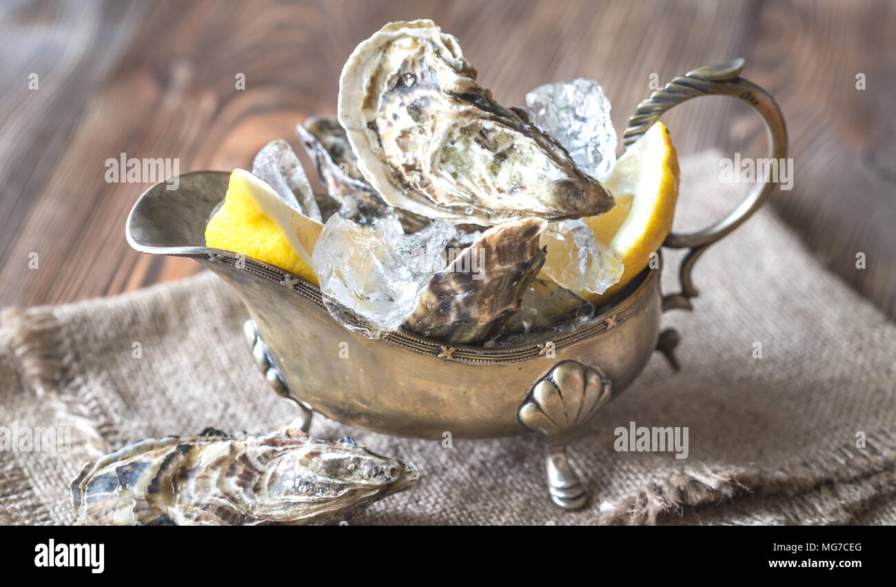 Raw oysters in the gravy boat Stock Photo Alamy