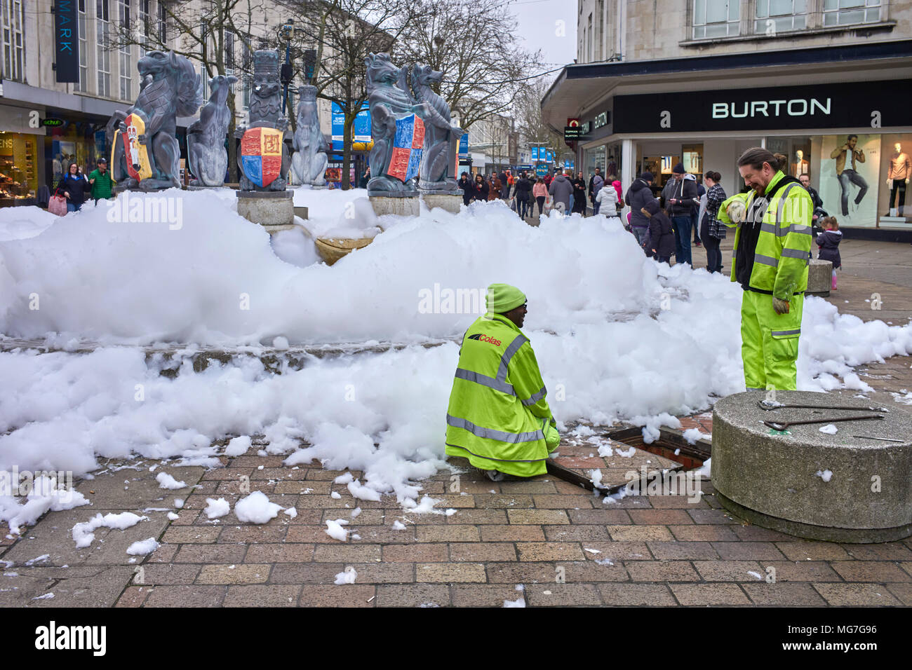 Council workmen turn off the water supply to the fountain in Commercial road Portsmouth after bubble mix had put into it. Stock Photo