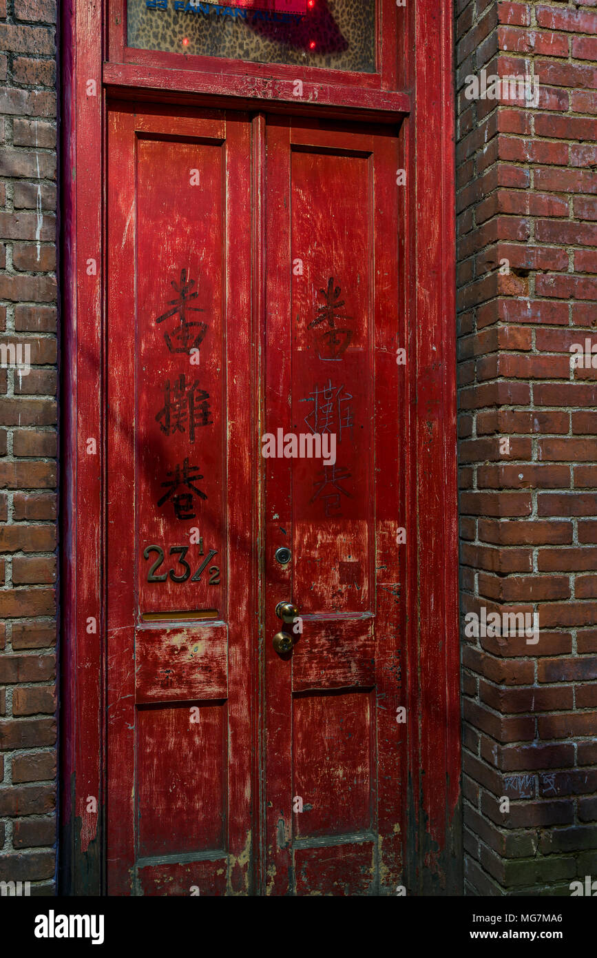 Red door at 23 1/2 Fan Tan Alley, Chinatown, Victoria, British Columbia, Canada. Stock Photo