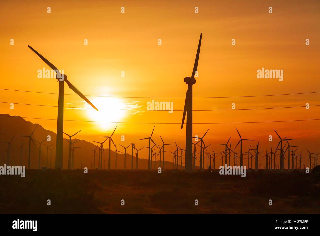 Silhouetted Wind Turbines Over Dramatic Sunset Sky Stock Photo - Alamy