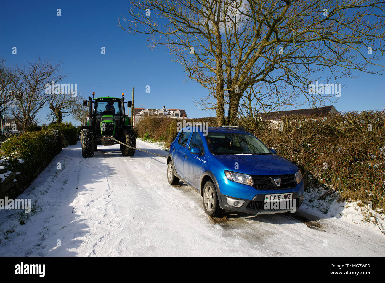 Vehicle on icy road Towed by tractor. Stock Photo