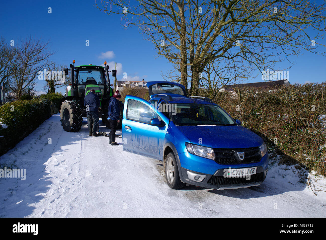 Vehicle on icy road Towed by tractor. Stock Photo